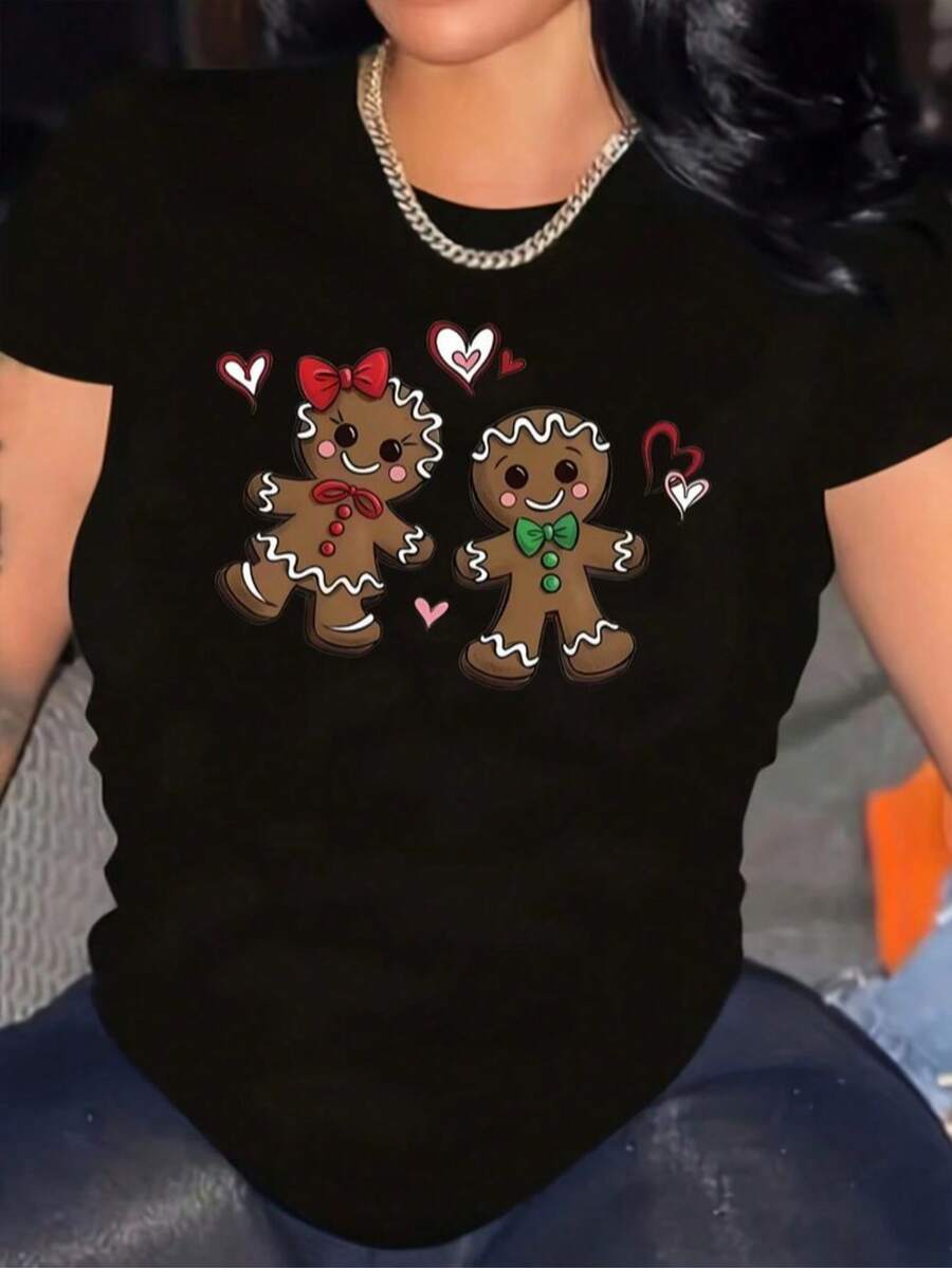 Playera color negro para mujer con estampado navideño moderno de pareja de galletas de jengibre sonrientes con detalles en rojo y verde rodeados de corazones festivos, ideal para un look alegre y juvenil durante la temporada decembrina, confeccionada en algodón suave para máxima comodidad, perfecta para combinar con jeans, leggins o faldas casuales,  para un estilo versátil y actual que transmite espíritu navideño con encanto - Negro - Ver 1