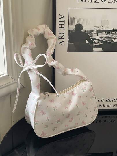 春夏新品 - 可爱花卉印花斜挎包，饰有丝带和蝴蝶结，轻质涤纶单肩包，适合通勤和旅行，黑白设计搭配粉色花卉图案，通勤包花卉印花轻便包