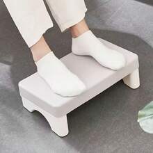 A Creative New Office Desk Accessory: A Leg Rest Bench Made Of PP Material. Designed With Ergonomic Principles For Comfortable Use While Working. Suitable For Various Settings Such As Offices, Sofas, And Study Rooms