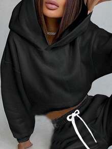 Sudadera corta de manga larga con capucha y forro polar, en color liso Sudadera corta ajustada con capucha, forro polar y cordón, ideal para la temporada otoño/invierno y para las mujeres que siguen las últimas de moda.Sudaderas de Mujer - Negro - Ver 6