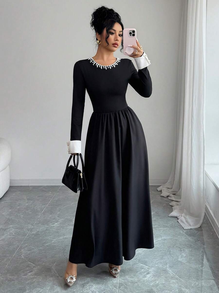 Sophisticated Women's Knitted Fabric Long Sleeve Black Dress, Featuring A Pearl-Detailed Round Neck, White Cuffs, And A Flared A-Line Silhouette For An Elegant Look