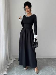 Sophisticated Women's Knitted Fabric Long Sleeve Black Dress, Featuring A Pearl-Detailed Round Neck, White Cuffs, And A Flared A-Line Silhouette For An Elegant Look