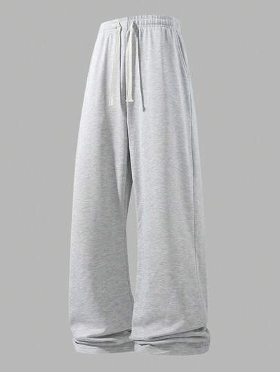 Pantalones deportivos holgados y de moda para hombres, de diseño de pierna ancha casual y sencillo de unicolor, con cordón y bolsillos grandes en la cintura, ligeros, adecuados para caminar a diario, trabajar, viajar, etc. Primavera