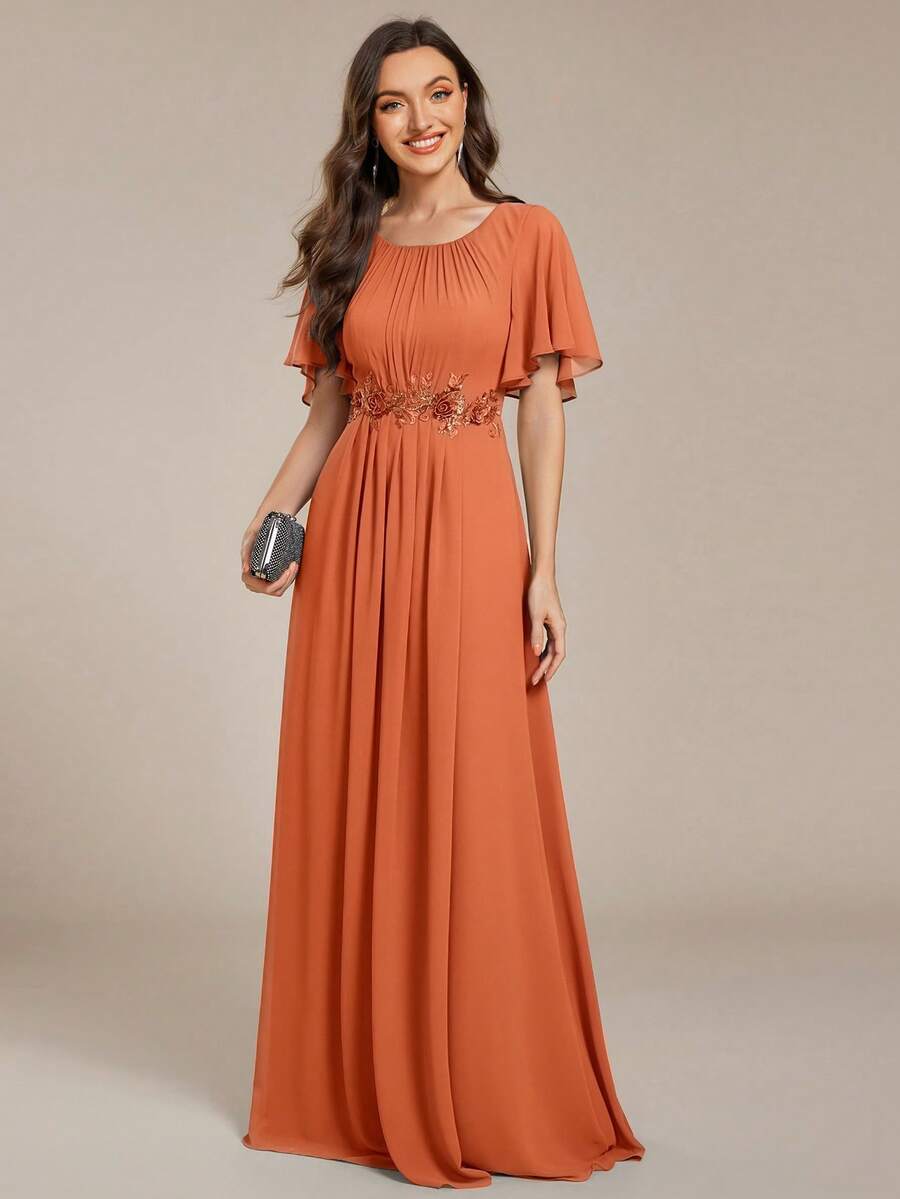 This Chiffon Bridesmaid Dress In Burnt Orange Features Embroidered Appliques, Ruffle Sleeves, And Pleating, Making It A Formal Long Dress Suitable For Wedding Guests.