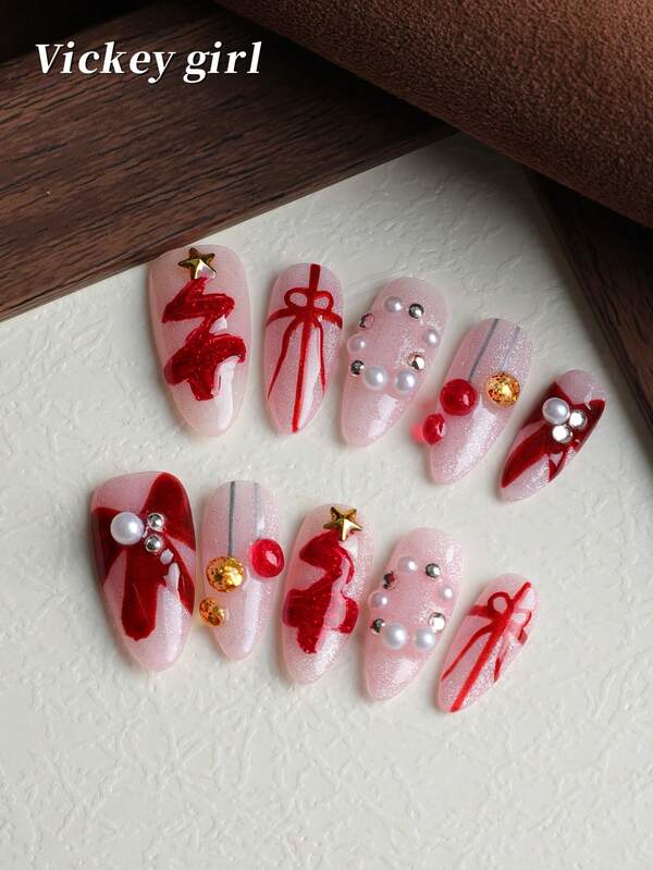أظافر عيد الميلاد اللؤلؤية الحمراء والشريط الوردي