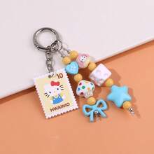 Sanrio Porte-clés chat KT avec nœud perlé style timbre de dessin animé. Style boho chic coréen . Charm de sac coloré noir et blanc. Accessoire de voiture. Cadeau pour femmes et hommes