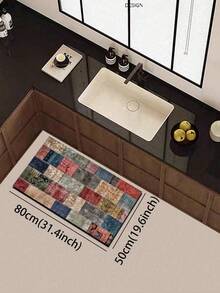 1片硅胶厨房地垫，拼布图案。地垫由许多不同颜色和图案的正方形拼接而成，包括红色、蓝色、米色、绿色等等。