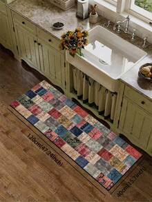 1片硅胶厨房地垫，拼布图案。地垫由许多不同颜色和图案的正方形拼接而成，包括红色、蓝色、米色、绿色等等。