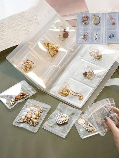 1 قطعة كتاب تخزين المجوهرات الشفاف المطفأ، كتاب تخزين العناصر الصغيرة القابل لإعادة الاستخدام، حقيبة تخزين المجوهرات البلاستيكية المتعددة الوظائف والمحمولة - صندوق تخزين - 84/160 جيب شفاف، حقيبة إغلاق مضادة للأكسدة، صندوق عرض كبير السعة، يمكن تخزين الأقراط والخواتم والقلائد، تخزين السفر