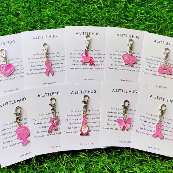 Conjunto de 10 chaveiros de liga de zinco com fivelas e laços natalinos para promover a saúde dos seios femininos. Ideais para decorar bolsas, carteiras, carros, professoras, amigas e irmãs. Perfeitos para presentear mulheres.