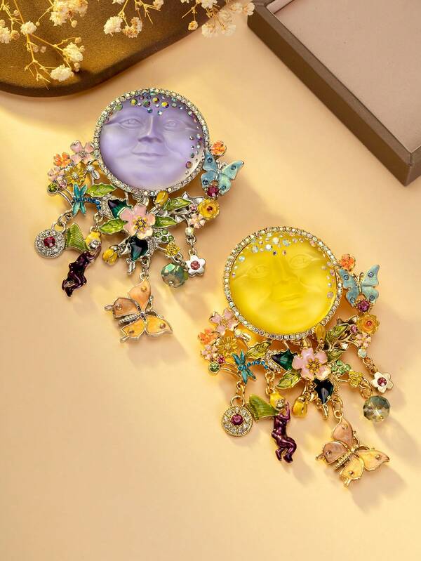 1pc Blue & 1pc Yellow Vintage Fantasy Moon Face Brooch, Amethyst-Like Lunar Surface Decorated With Colorful Crystals, Enamel Floral, Butterfly & Fairy Charms Intertwined, Suitable For Adorning Retro Jackets Or Boho Outfits To Instantly Evoke A Whimsical, Magical Aesthetic.