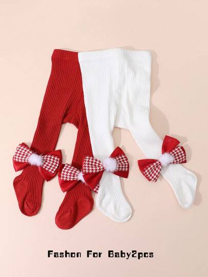 قطعتان من جوارب الأطفال البنات الحمراء المزينة بفيونكة، مناسبة للارتداء في عيد الميلاد ورأس السنة الجديدة