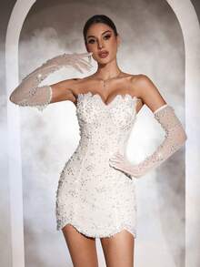 Đầm cưới Astony One màu trắng thanh lịch với điểm nhấn ngọc trai giả sang trọng, thiết kế cúp ngực gợi cảm, vạt áo bất đối xứng ôm sát, kết hợp với tay áo trắng, tôn lên vóc dáng duyên dáng. Hoàn hảo cho đám cưới, lễ đính hôn, tiệc sinh nhật, tiệc cưới, lễ hội, dã ngoại, lễ hội âm nhạc, dạ hội trang trọng và các sự kiện thảm đỏ. Tiệc mùa xuân - trắng - Xem 6