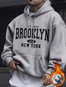 男士休闲宽松连帽卫衣，带抽绳口袋设计，适合居家和户外穿着，秋冬季长袖上衣