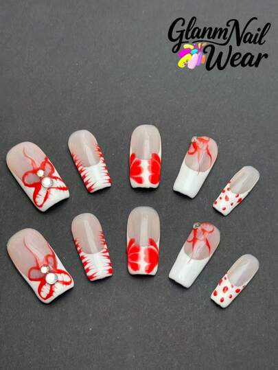 10 مسامير مربعة مصنوعة يدويًا، مع التركيز على تناسق الألوان الأحمر والأبيض، حيث تظهر الأنماط الحمراء على خلفية بيضاء وعارية، مع تزيينات من الراين، الأسلوب أكثر تخصيصًا وفنيًا قليلاً.