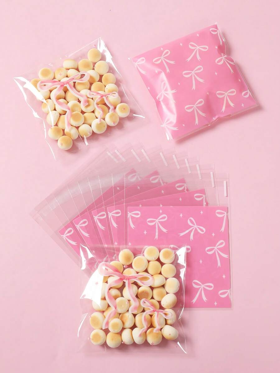 50/100 Stücke rosa Schleifenmuster Süßigkeiten Selbstversiegelungsbeutel, Geschenktüten, Geschenkverpackungstüten, Snackbeutel, Verpackungstüten, rosa Schleifen Party Dekorationen, Baby Shower Dekorationen, Snack Schokoladen Keks Backtüten, Donut Tüten, Brautparty Gastgeschenke, Gender Reveal Party Zubehör, 1. Geburtstags Party Dekorationen, Baby Mädchen Party Zubehör, Prinzessin Themen Party Zubehör, Baby Mädchen Geschenke - Rosa Schleife - Übersicht 1