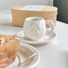 A Set Of Ceramic Coffee Cups And Saucers With Bow-Tie Relief Design (100-180ml Capacity). Perfect For Home Kitchens, Dining Rooms, Or Living Spaces. Each Cup Comes With A Matching Saucer. Ideal For Serving Tea, Coffee, Milk, Water, Or Juice. Suitable For Outdoor Use, Weddings, Parties, Gifting, Or Birthdays.