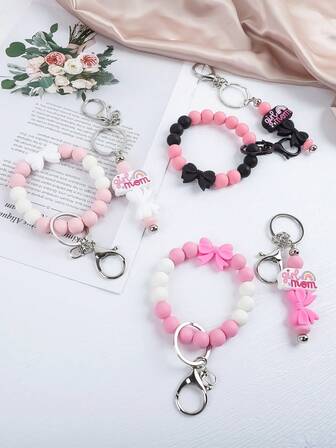 1ชิ้น กำไลข้อมือลูกปัดน่ารัก "Mom's Girl" พวงกุญแจ | โบว์สีชมพู/ดำ สร้อยข้อมือเสน่ห์สายรุ้ง พวงกุญแจ | เสน่ห์เครื่องประดับแฟชั่นสำหรับแม่/ผู้หญิง