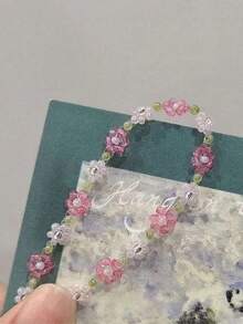 这款新款时尚珍珠花朵弹力可调节串珠手链是一款甜美简约的配饰，适合女性佩戴。 - 紫黃白 - 查看 3