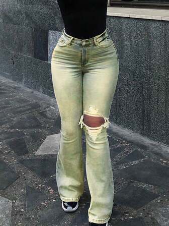 Damjeans med slitna, elastiska, smala utsvängda jeans