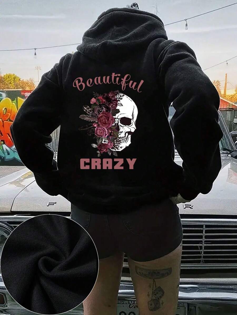 大码女式休闲连帽长袖卫衣，白色骷髅头图案搭配深粉色玫瑰羽毛，粉色“Beautiful”和“CRAZY”字母印花，适合春、夏、秋季穿着。这款大码女式长袖卫衣也是感恩节、度假和其他场合的理想之选。黑色 - 黑色 - 查看 1