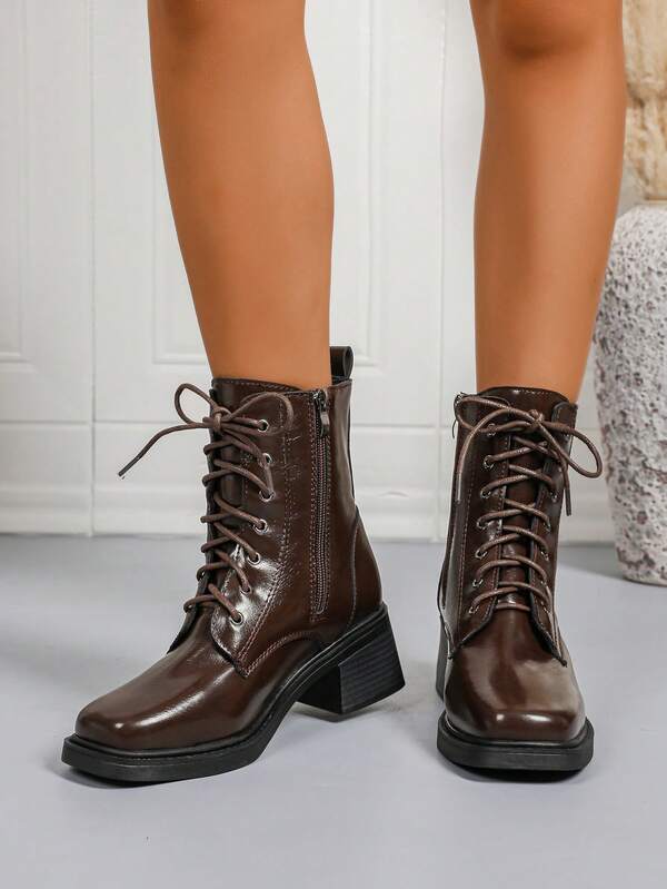 بوت غربية قصيرة بنمط بريطاني كلاسيكي، مزودة بإبزيم معدني وفتحات، مناسبة للخريف والشتاء، ذات سُمك في الأرضية وأصابع مربعة، مربوطة بأربطة
