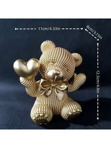 1件树脂小熊手捧爱心摆件，饰以缤纷色彩，是婚礼或情人节的理想礼物，适合摆放在客厅、书架、办公室，亦可作为家居装饰或优雅的节日摆件，共有4种颜色可选。