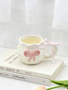 1pc Creative 3D Embossed Hand-Painted Bow Design Ceramic Coffee Mug With Ribbon, Delicate Packaging, Ideal For Gifts