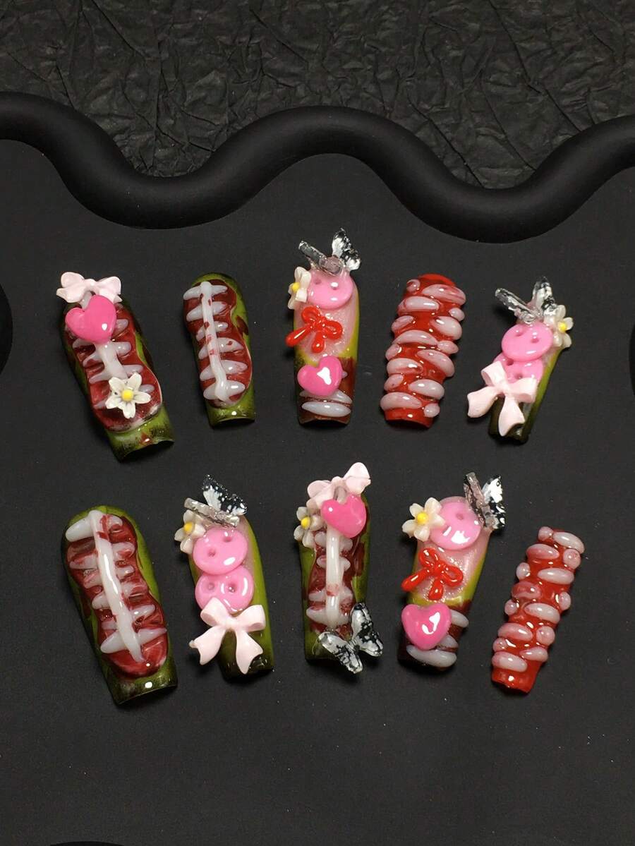 10-Piece Handmade Dark Sweet-Cool Pipe-Shaped False Nails Handcrafted With A Skeletal-Texture Base (Rib/Muscle Details), Paired With Pink Hearts, Bows & Flowers For A Bold "Dark + Sweet" Contrast. Rich In Red/Green/Pink Hues (Eye-Catching Visual Conflict) + 3D Resin Accents (Buttons, Butterflies) & Glossy Lacquer For Vivid 3D Texture. Nail Supplies - 彩色 - 查看 1
