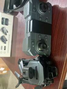 O Drone K6 com Câmera possui Câmeras Duplas de Alta Definição, Hover com Fluxo Óptico e Desvio Inteligente de Obstáculos. É um Quadricóptero Multirrotor. Câmera, Drone Brinquedo Controlado por Controle Remoto. Prazeres de Viagem Interno/Externo incluem: Bolsas de Armazenamento Profissionais e Lâminas de Hélice Sobressalentes, Múltiplas Configurações de Bateria, Proporcionando Presentes de Aniversário Perfeitos para Homens/Mulheres, Presentes de Natal/Halloween/Ano Novo