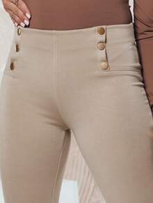 Pantaloni da donna a vita alta con bottoni decorativi, vestibilità slim che esalta la silhouette, pantaloni in cotone elasticizzato ed elegante con tasche posteriori, comodi leggings per look sia da giorno che da sera