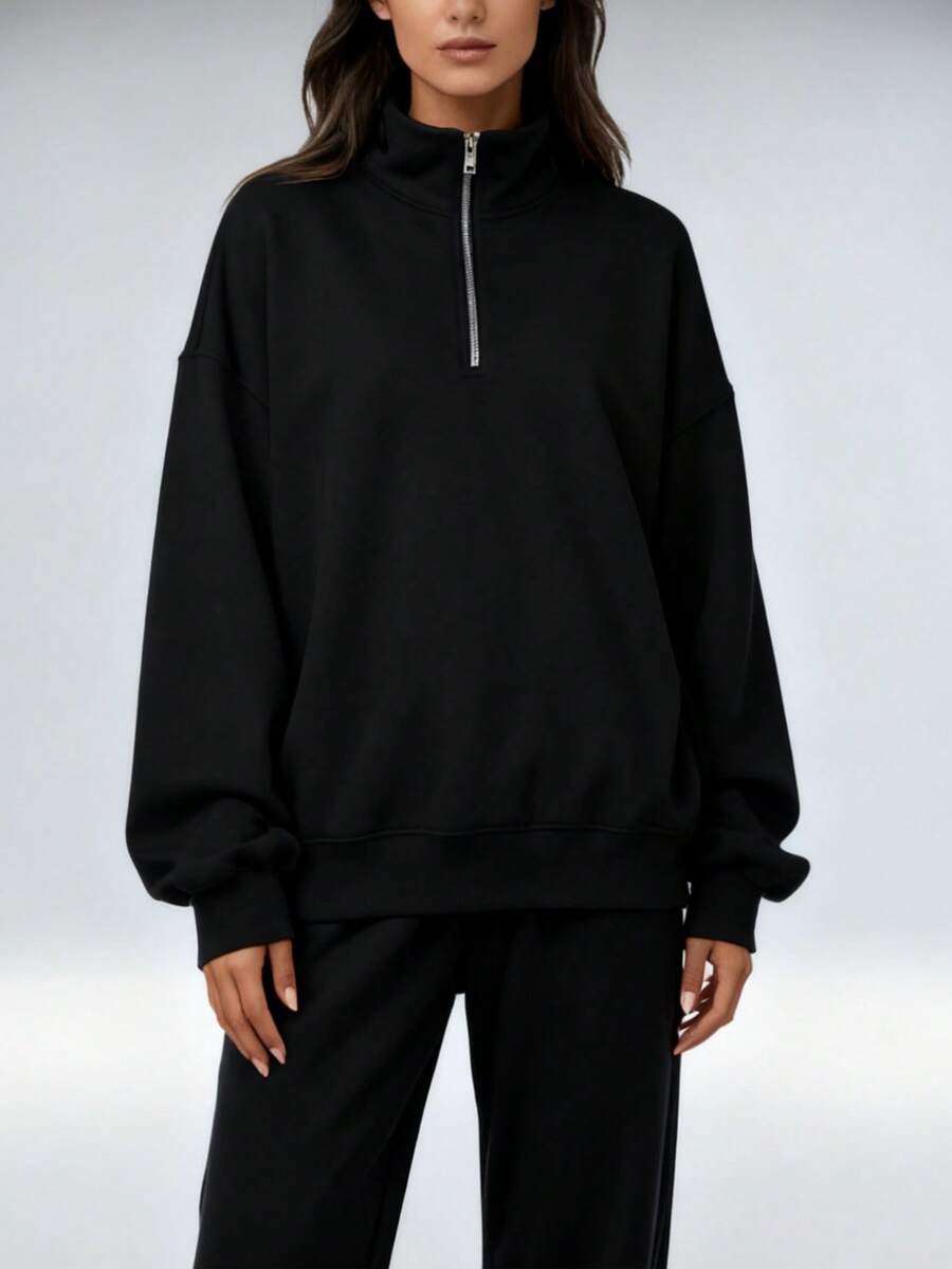 A Loose-Fitting Women's Sweatshirt With A Half-Zip Stand-Up Collar And Drawstring Casual Pants Creates A Relaxed And Sporty Women's Set. This Outfit Features A Loose And Casual Fit, Perfect For Comfortable Everyday Wear. - màu đen - Xem 1