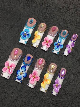 This Is A 10-Piece Handcrafted Coffin-Shaped Press-On Nail Set-A Colorful 3D Floral-Style Extended Press-On Nail Collection. With White And Light Pink As The Base, It Is Paired With Handcrafted 3D Colorful Floral Decorations In Shades Of Blue, Yellow, Pink, And Purple, Complemented By Matching Rhinestone And Bead Edging, Presenting A Lively And Sweet Overall Style.