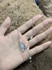 1pc Butterfly Tassel Necklace Designed For Modern Women Who Appreciate Light Luxury And Korean Style Aesthetics This Elegant Piece Features A Delicate Butterfly Pendant With A Flowing Tassel Creating A Captivating Movement That Adds A Touch Of Femininity To Any Outfit Crafted With Hypoallergenic Materials And An Adjustable Chain It Ensures Comfortable All Day Wear Without Irritating Sensitive Skin The Waterproof And Tarnish Resistant Properties Maintain Its Radiant Appearance Through Continuous Wear Making It Perfect For Daily Activities Whether Youre Attending A Party Wedding Music Festival Or Enjoying A Beach Vacation This Necklace Effortlessly Enhances Your Style Its A Thoughtful Gift For Girlfriend Mom Daughter Or Friends Celebrating Special Occasions Like Birthdays Anniversaries Or Holidays With Its Timeless Design And Meaningful Symbolism