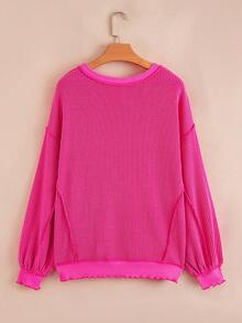 Top tricoté ample à épaules tombantes, ourlet irrégulier, côtes torsadées, couleur rose fraise