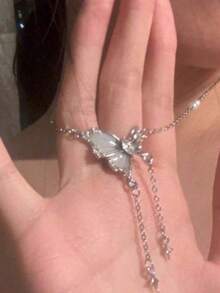 1pc Butterfly Tassel Necklace Designed For Modern Women Who Appreciate Light Luxury And Korean Style Aesthetics This Elegant Piece Features A Delicate Butterfly Pendant With A Flowing Tassel Creating A Captivating Movement That Adds A Touch Of Femininity To Any Outfit Crafted With Hypoallergenic Materials And An Adjustable Chain It Ensures Comfortable All Day Wear Without Irritating Sensitive Skin The Waterproof And Tarnish Resistant Properties Maintain Its Radiant Appearance Through Continuous Wear Making It Perfect For Daily Activities Whether Youre Attending A Party Wedding Music Festival Or Enjoying A Beach Vacation This Necklace Effortlessly Enhances Your Style Its A Thoughtful Gift For Girlfriend Mom Daughter Or Friends Celebrating Special Occasions Like Birthdays Anniversaries Or Holidays With Its Timeless Design And Meaningful Symbolism