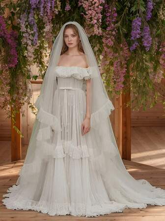 En lång, dubbelskiktad, volangformad brudslöja, elegant och enkel, är ett idealiskt val för en kvinnas brudklänning
