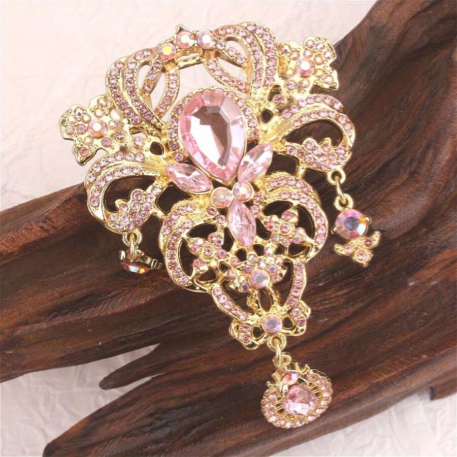 Gold-Tone Luxurious Pink Crystal Brooch With Intricate Vintage Design & Dangle Drop, Ornate Statement Pin For Formal Events & Gifting, Ideal For Retro Jewelry Enthusiasts - Pink - View 1