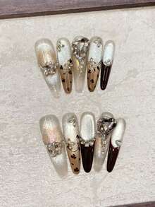 冬季美甲套装，10片椭圆形长尖甲片，棕色手绘豹纹美甲，棕色法式美甲，手绘不对称线条装饰，闪亮猫眼，歪心K9钻石镶嵌设计，小钻石缝线，高端奢华，适合约会、聚会、外出游玩等场合，可佩戴，可重复使用，手工按压式美甲套装，含果冻胶，迷你Rub One美甲用品手工按压式美甲片。 - 咖啡棕 - 查看 2