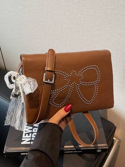 时尚韩版可爱铆钉蝴蝶结单肩包，别致个性化斜挎包带吊坠