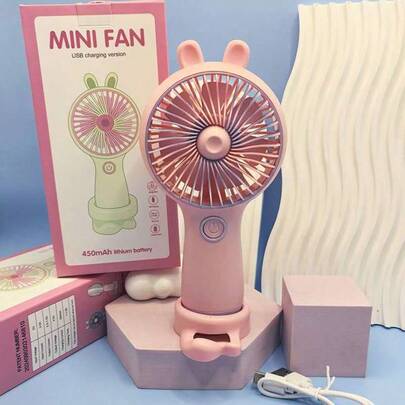 Ventilador portátil de oído de conejo con soporte para móvil, modelo recargable, mini ventilador de tres velocidades ajustables en la mesa.