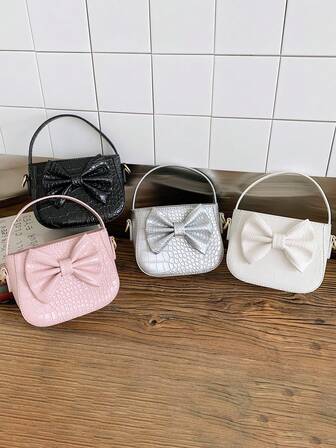 1个女童蝴蝶结装饰PU手提包，斜挎水桶包，适合日常、派对、活动等场合使用。