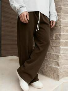 1 件男士抽绳腰宽松阔腿休闲运动裤，秋冬