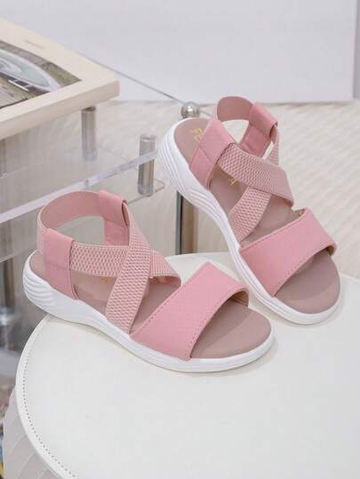 A Pair Of New Summer Cross-Strap Sandals For Children In 2025 - Pink Design, Simple, Fashionable, Casual And Comfortable. It's An Excellent Choice For Campus Life, Daily Outings, Park Walks And Beach Play, And Can Be Easily Matched With All Kinds Of Children's Clothing