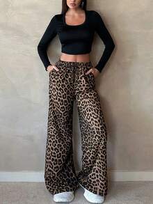 Pantalones largos rectos con cintura elástica y estampado de leopardo.Pantalones de diseño con estampado de leopardo para mujer, estilo chic y desenfadado. Pantalones rectos de cintura alta. Pantalones anchos y holgados con elegante caída. Pantalones largos hasta el suelo con silueta fluida. - Negro - Ver 3