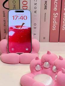 1个可爱猫爪造型桌面手机支架，色彩鲜艳，设计新颖，充电方便，防滑，适用于多种场景，包括手机支架、桌面支架、防滑塑料平板电脑支架，不含电池