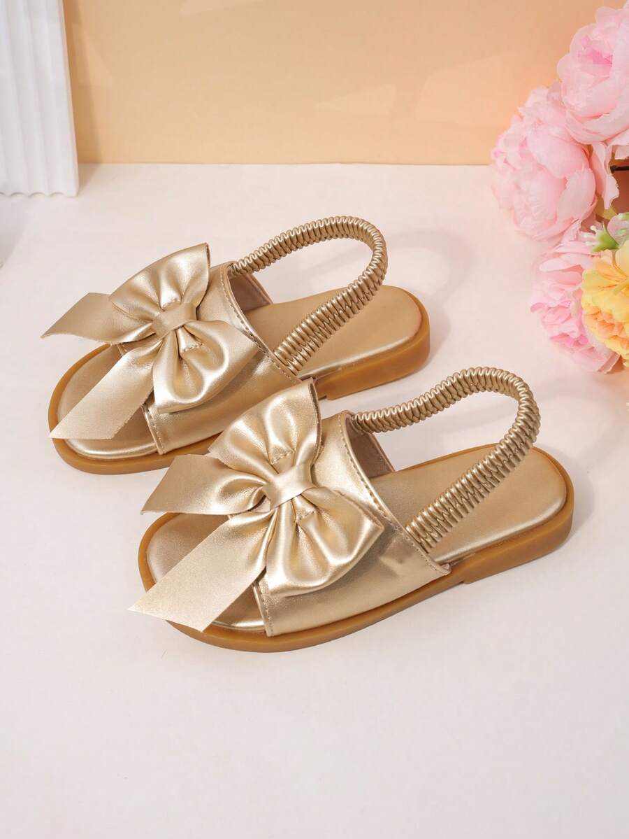 1 Pair Of Children's Golden Bow Sandals With Metallic PU Material, Exposed Toe, Low Cut Elastic Band, Flat Heel, Sweet And Elegant Style, Party Performance, Daily School Shoes - Gold - View 1