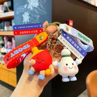 一件原创运动玩具钥匙扣，一个有趣的卡通羽毛球书包钥匙扣吊坠，以及一件创意网球比赛纪念品。