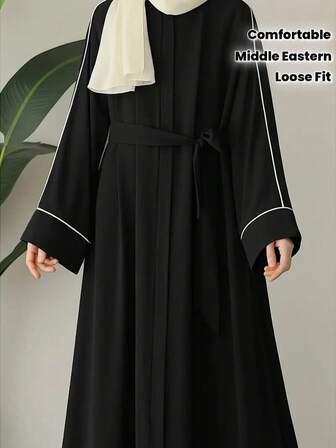 Vestido largo tejido negro con ribete blanco, cuello redondo, manga larga, corte holgado, adecuado para mujeres