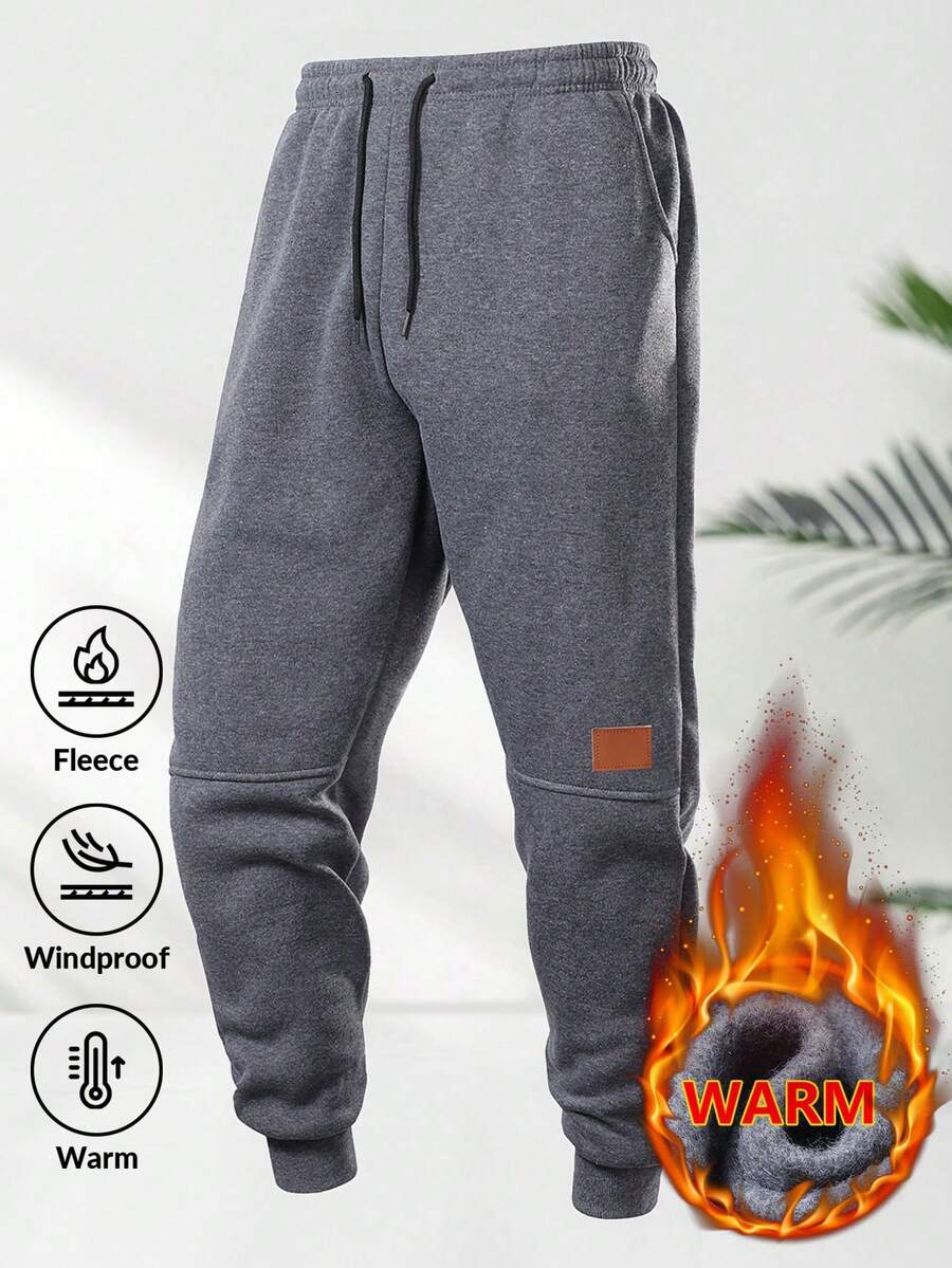 男士保暖运动裤，带口袋和抽绳，撞色皮革贴片，腰部可调节，裤脚收口，穿着舒适。 - 深灰色 - 查看 1